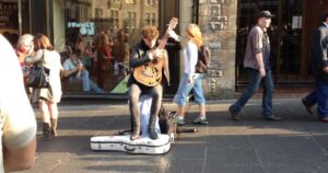 person playing guitar on the street