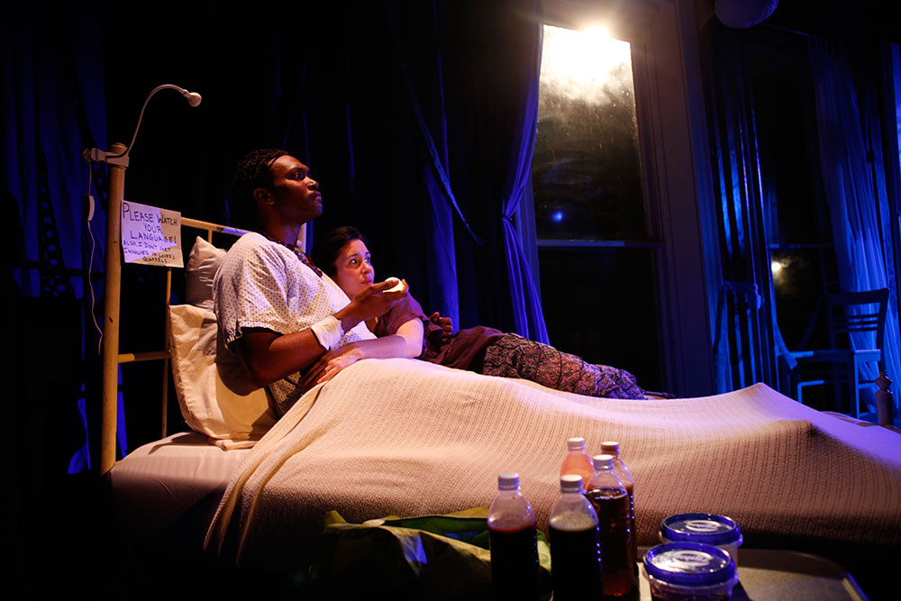 Actors in bed on set