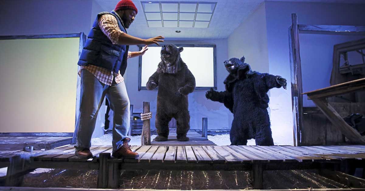 actor on stage with bears