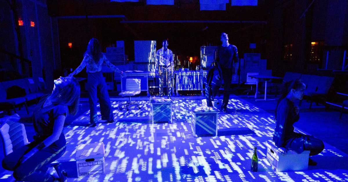 Actors on a blue lit stage