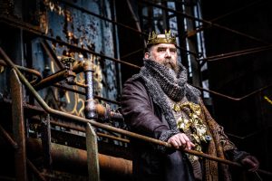 King Lear (Jeffrey Carpenter) stands over his rusty kingdom at the historic Carrie Blast Furnaces.
