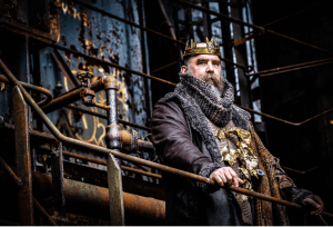 King Lear (Jeffrey Carpenter) stands over his rusty kingdom at the historic Carrie Blast Furnaces.