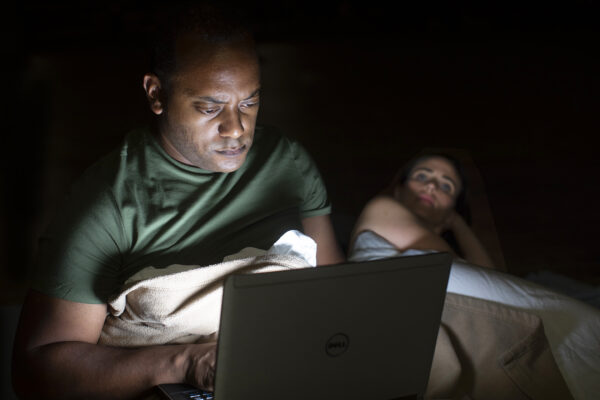 Kyle Haden on laptop in bed