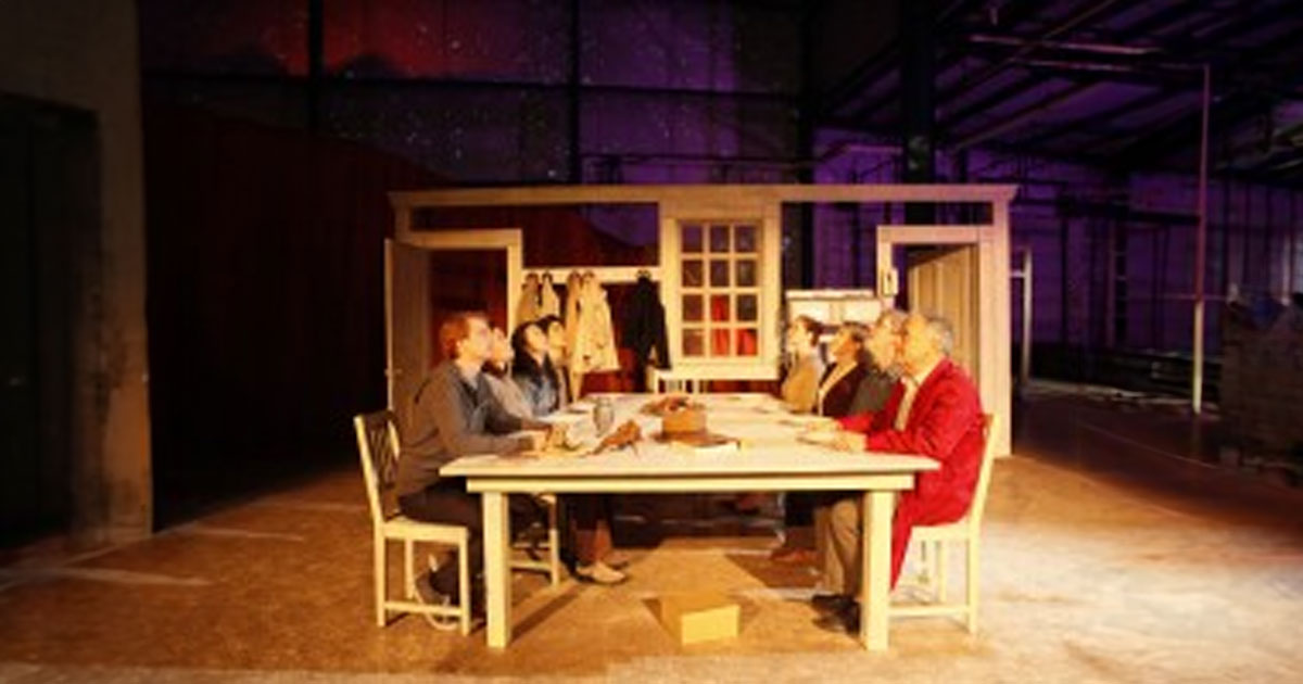 Actors at table on stage